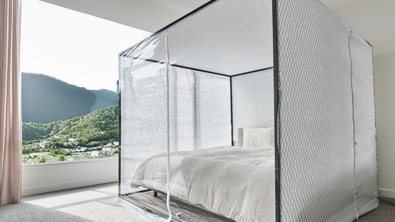 Sleep Cloud altitude tent standing over a bed